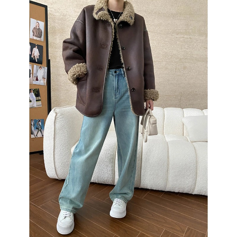 Brown shearling jacket with light blue wide-leg jeans and white sneakers, stylish fashion ملابس