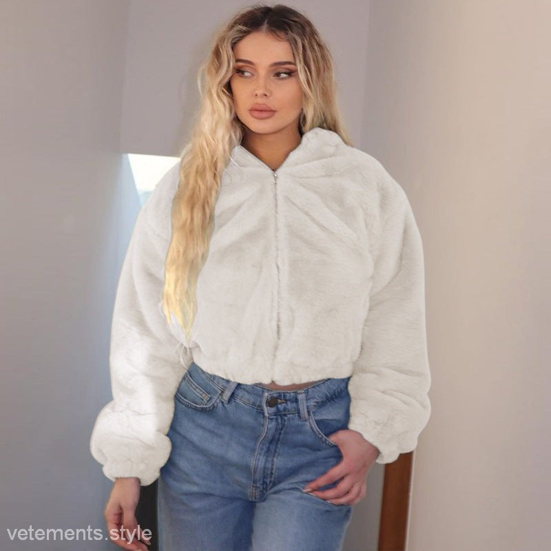 Woman in a white faux fur jacket with blue jeans showcasing the Autumn Hooded Plush Long