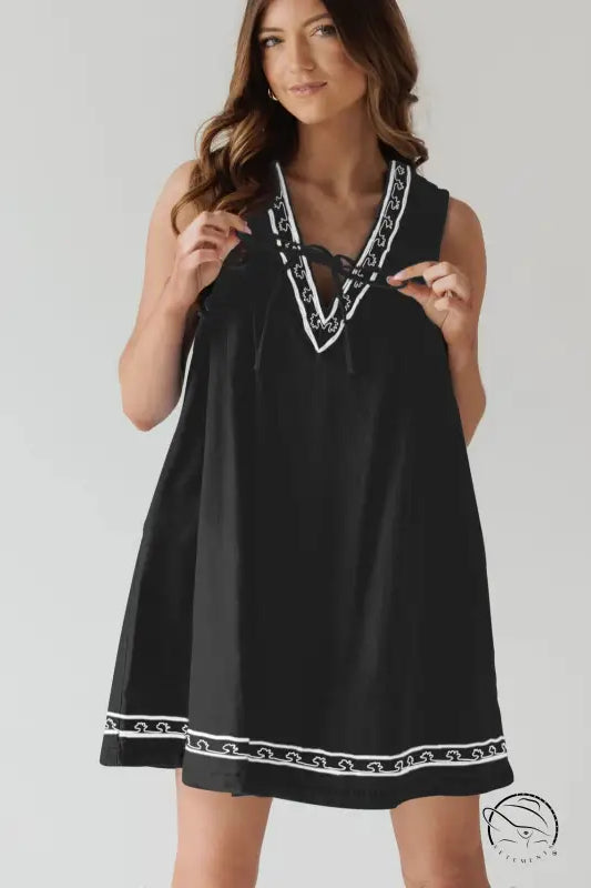 Beautiful embroidered vest denim dress in black with white trim