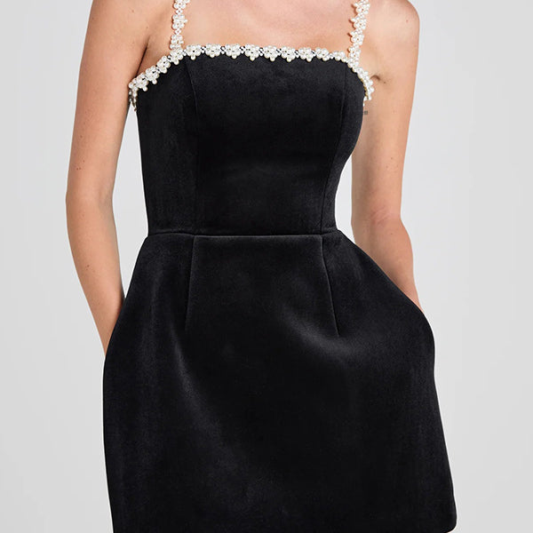 Elegant black velvet mini line dress with pearl trim for sophisticated fashion style