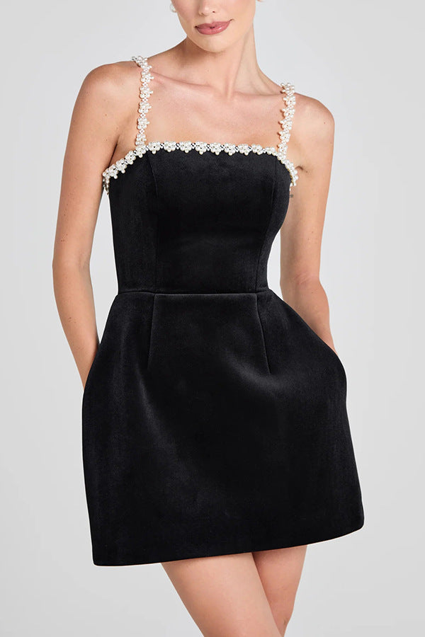 Elegant black velvet mini line dress with pearl trim for sophisticated fashion style
