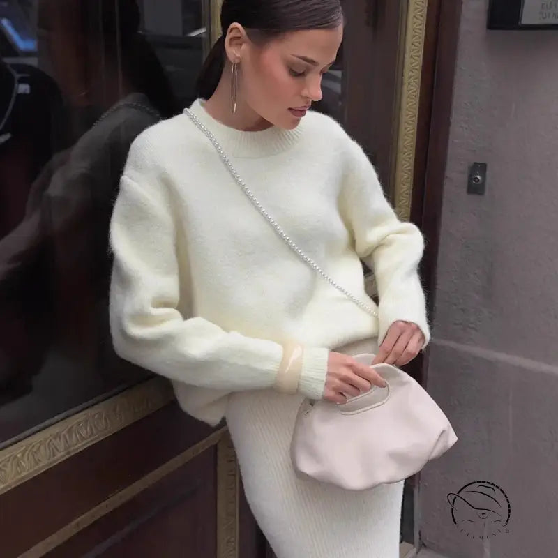 Cream cashmere sweater with silver chain detail and wool alpaca skirt