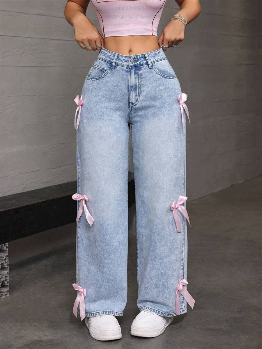 Light blue denim loose straight leg jeans with pink ribbon accents for a stylish look