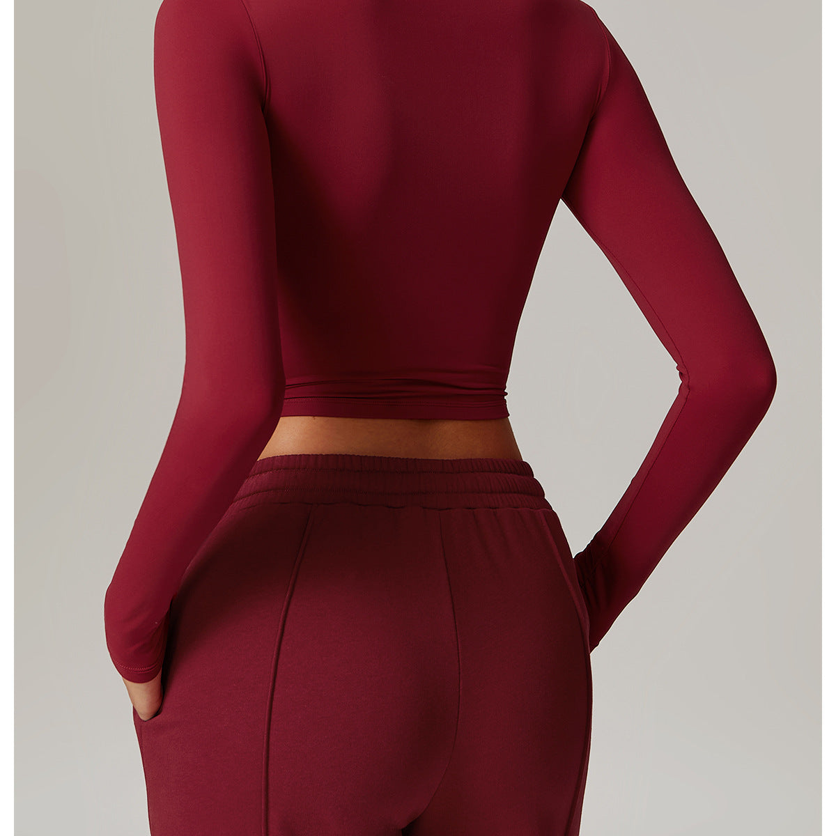 Burgundy long-sleeved crop top with high neckline for stylish fitness fashion ملابس