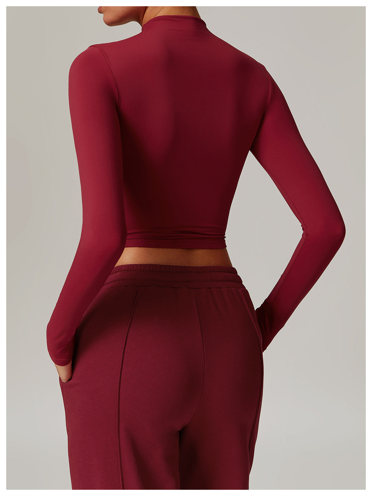 Burgundy long-sleeved crop top with high neckline for stylish fitness fashion ملابس
