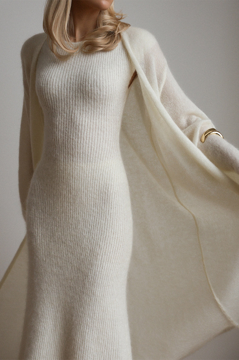 Cream knit sleeveless dress with long sleeves and gold bracelet