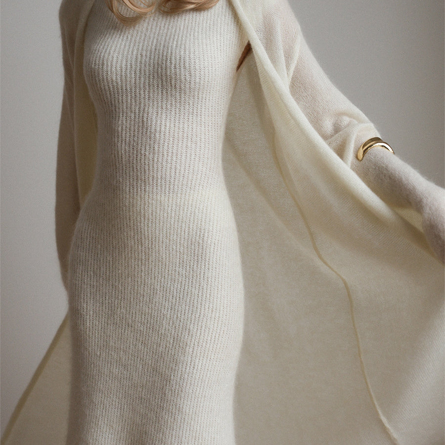 Cream knit sleeveless dress with long sleeves and gold bracelet