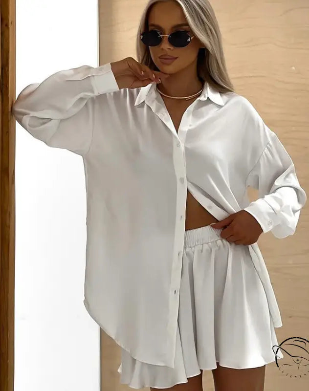 Woman in soft two piece pajamas: white button-down shirt and shorts