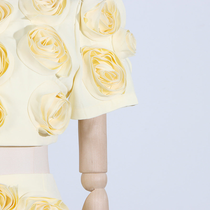 Cream-colored roses on a wooden pedestal complement the French Sweet Summer fashion set