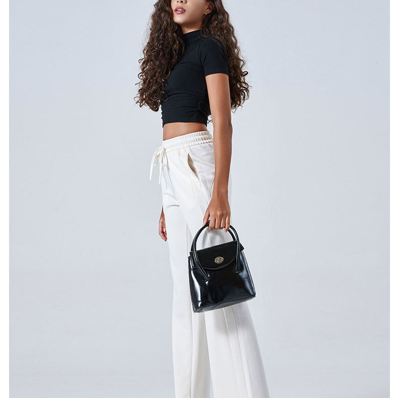 Person in black crop top and white drawstring pants showcasing stylish ملابس for summer