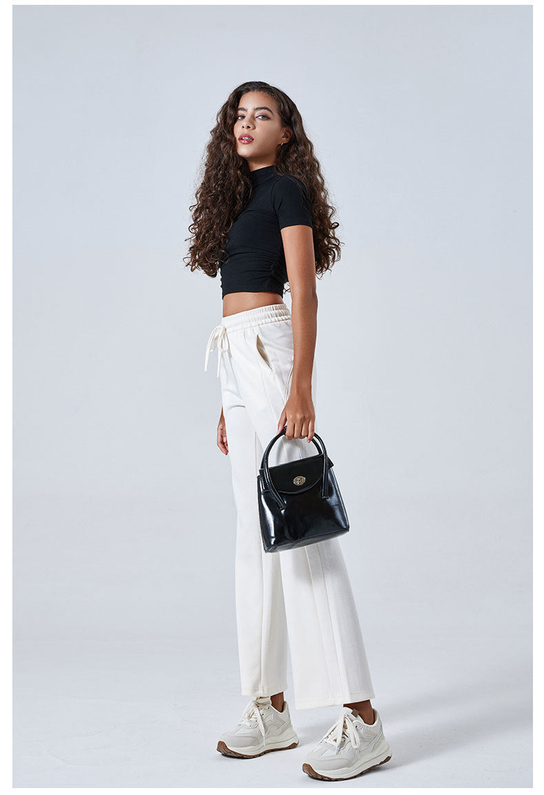 Person in black crop top and white drawstring pants showcasing stylish ملابس for summer