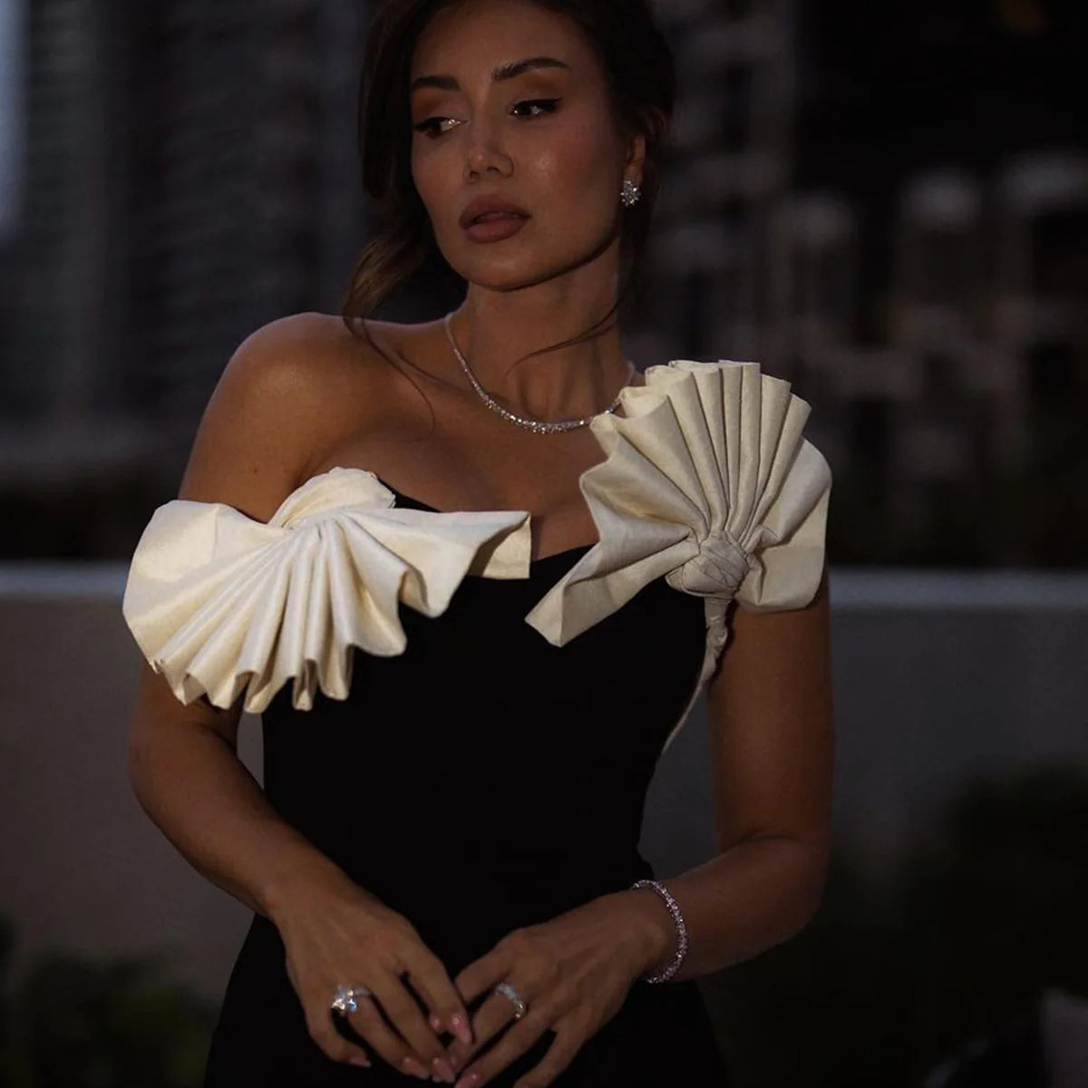 Elegant black dress featuring dramatic white ruffles, perfect for langry fashion ملابس