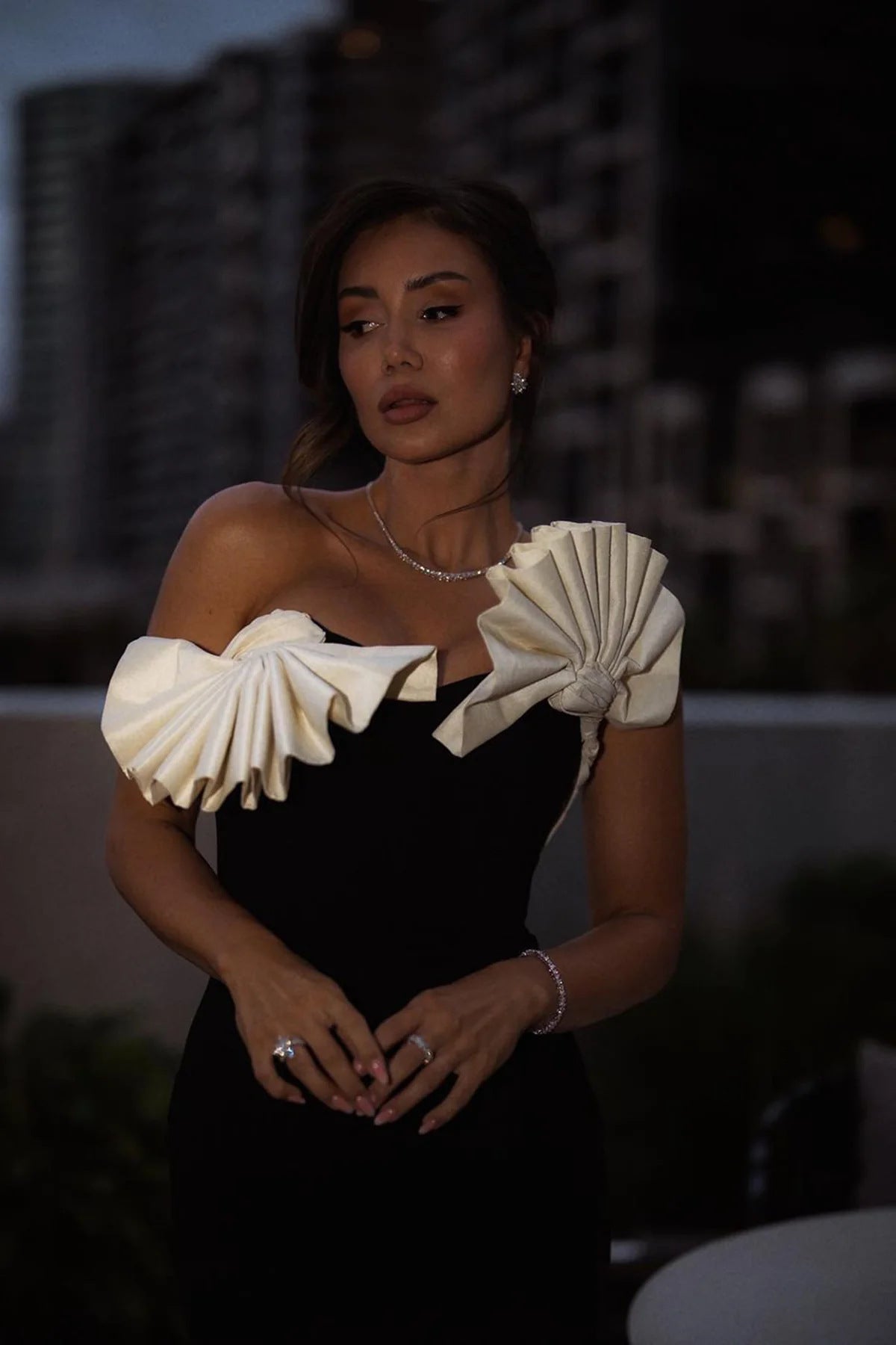 Elegant black dress featuring dramatic white ruffles, perfect for langry fashion ملابس