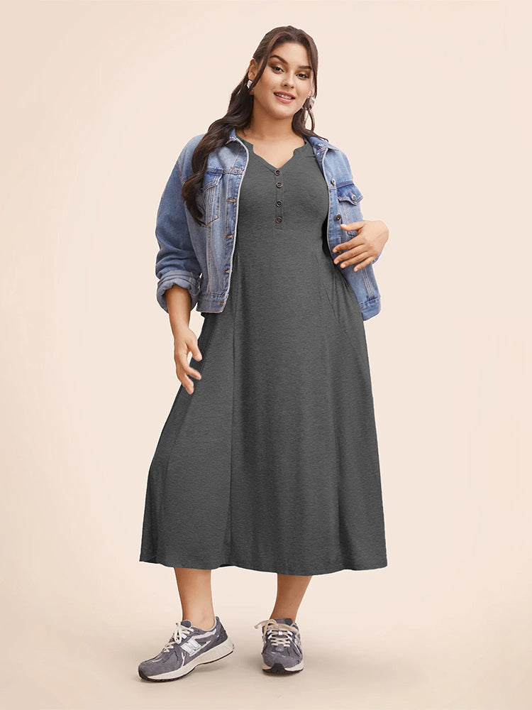 Woman in winter loose langry fashion midi dress with denim jacket and athletic shoes