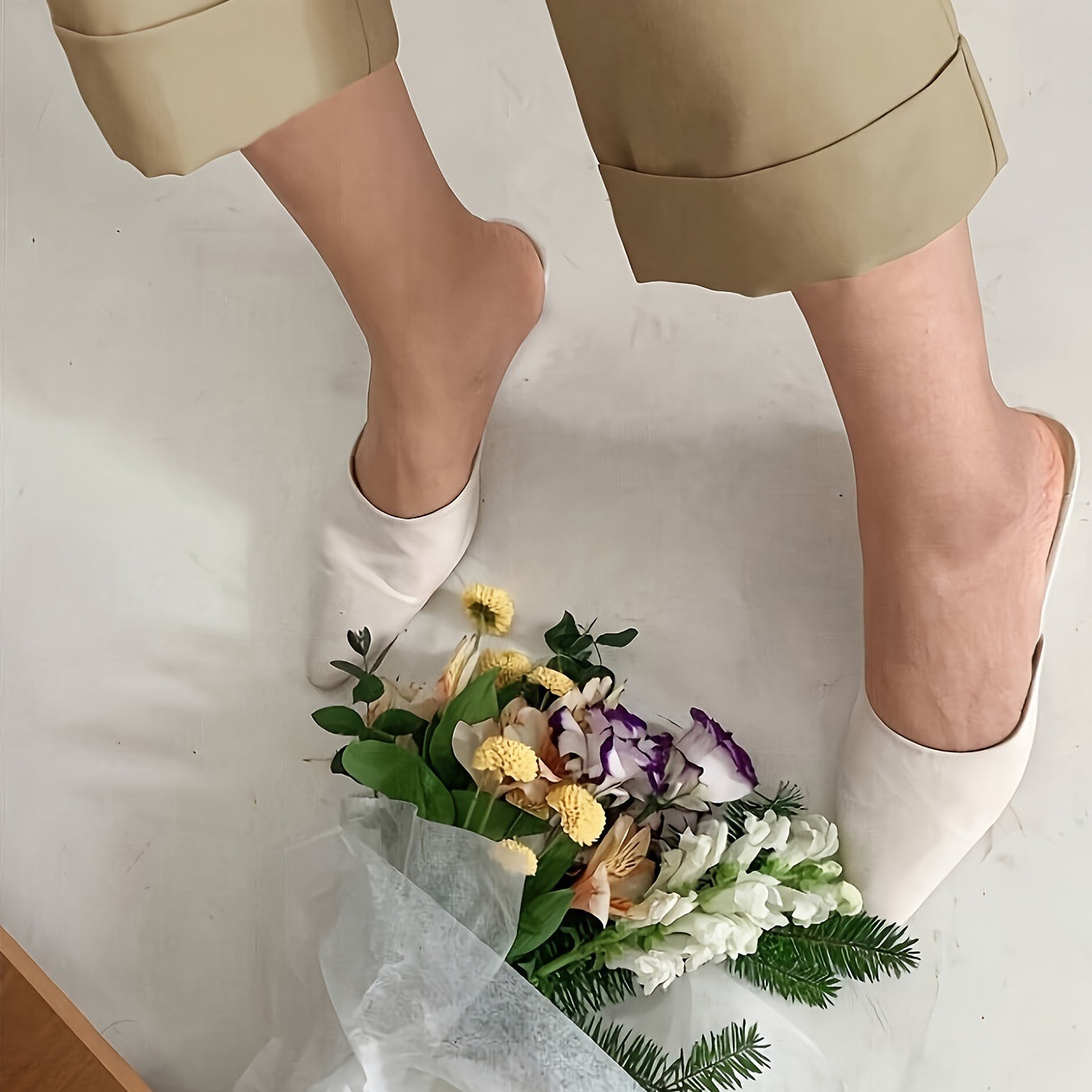 White slippers on a floral bouquet beside Office Drooping Slimming Wide Leg Pant