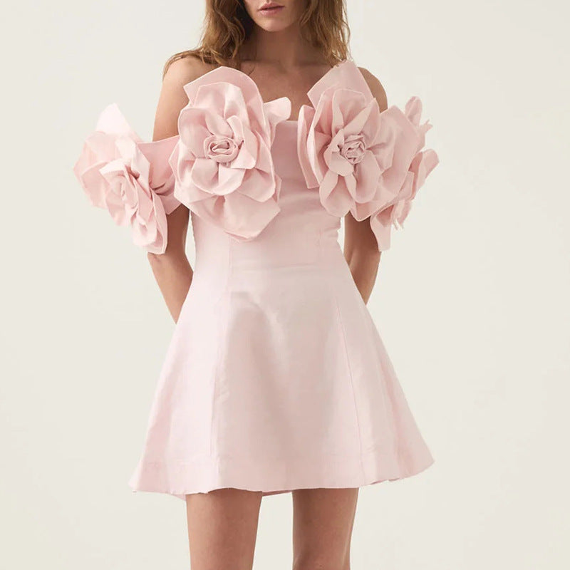 Pink off-shoulder mini dress with floral appliques, perfect for elegant fashion occasions