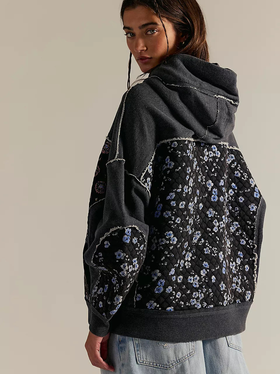 Black floral langry hooded embroidery sweater with gray sleeves and denim jeans