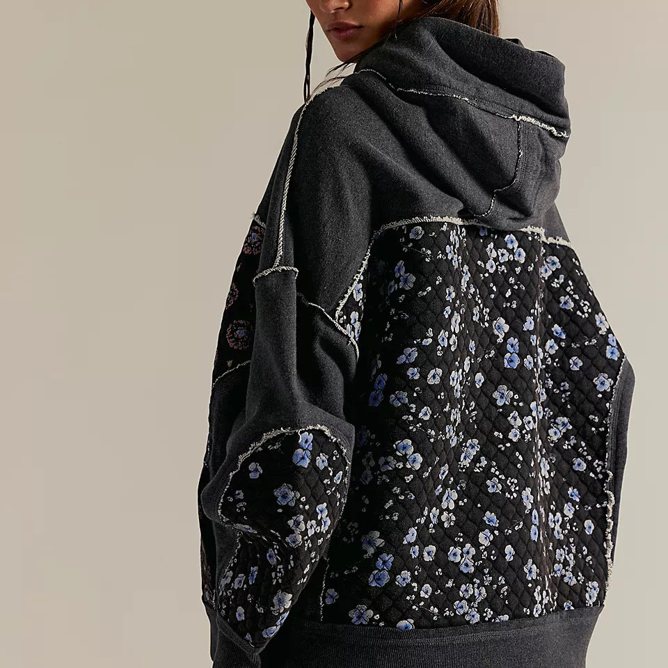 Black floral langry hooded embroidery sweater with gray sleeves and denim jeans