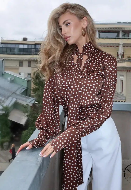 Elegance polka dot shirt: brown blouse with white pants and gold hoop earrings