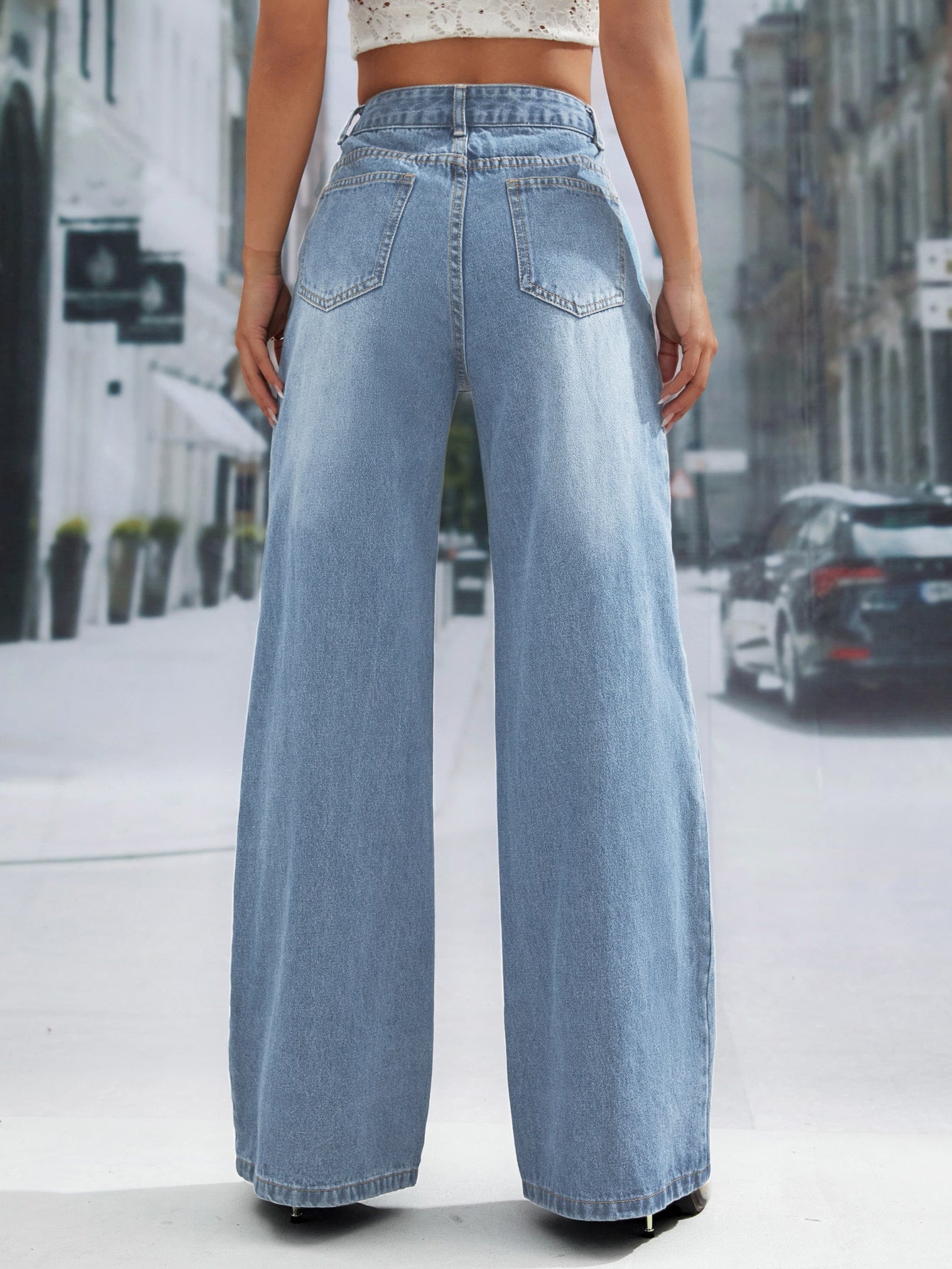 Light-wash wide leg denim trousers with high waist and back pockets for a stylish look
