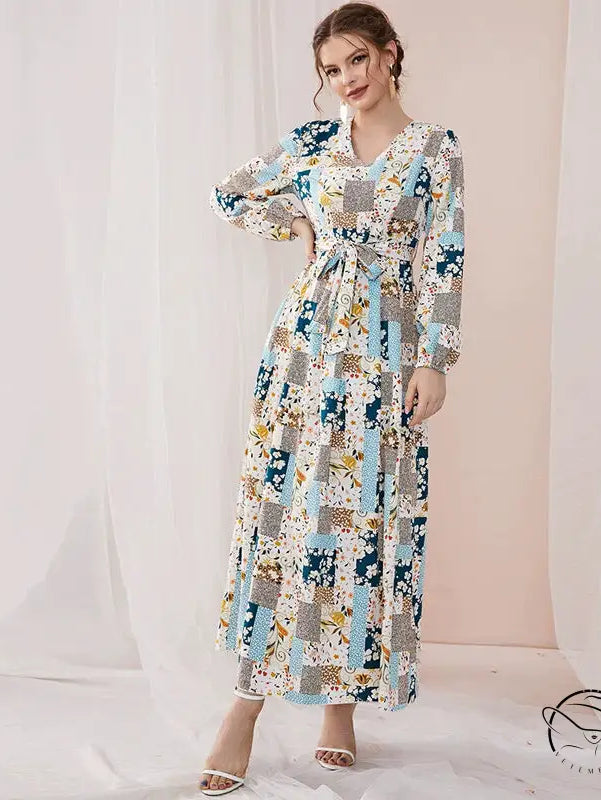 Woman in floral print slim fit maxi dress with blue beige gray patchwork