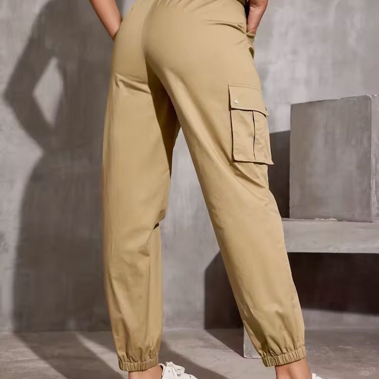 Beige cargo pants with elastic cuffs styled with white sneakers in casual fashion ملابس