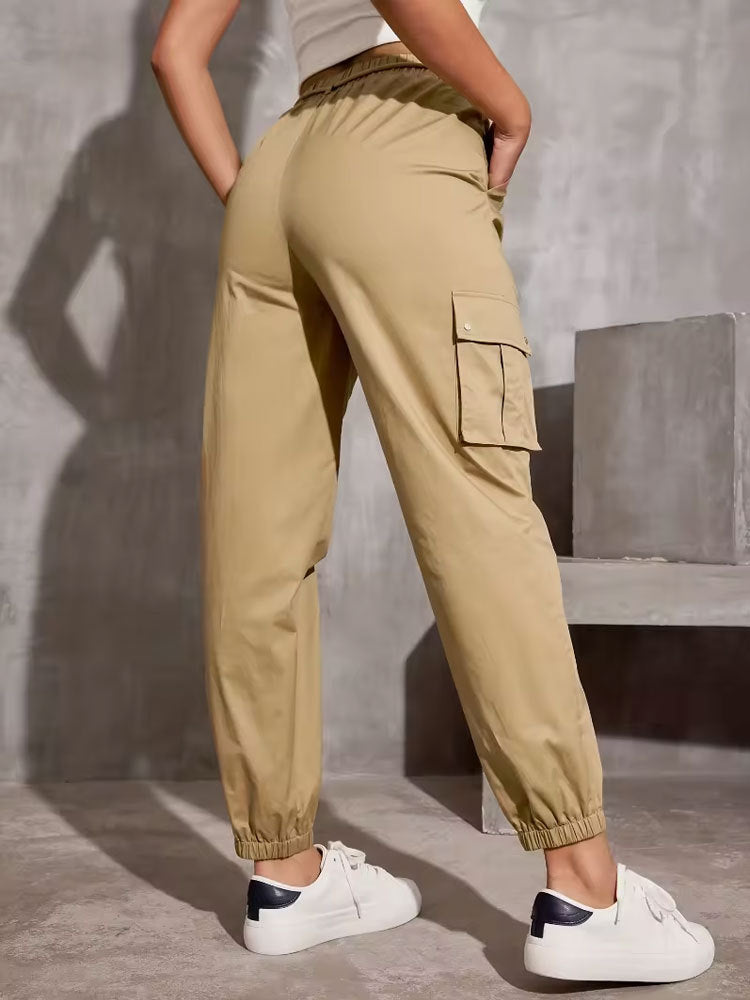 Beige cargo pants with elastic cuffs styled with white sneakers in casual fashion ملابس