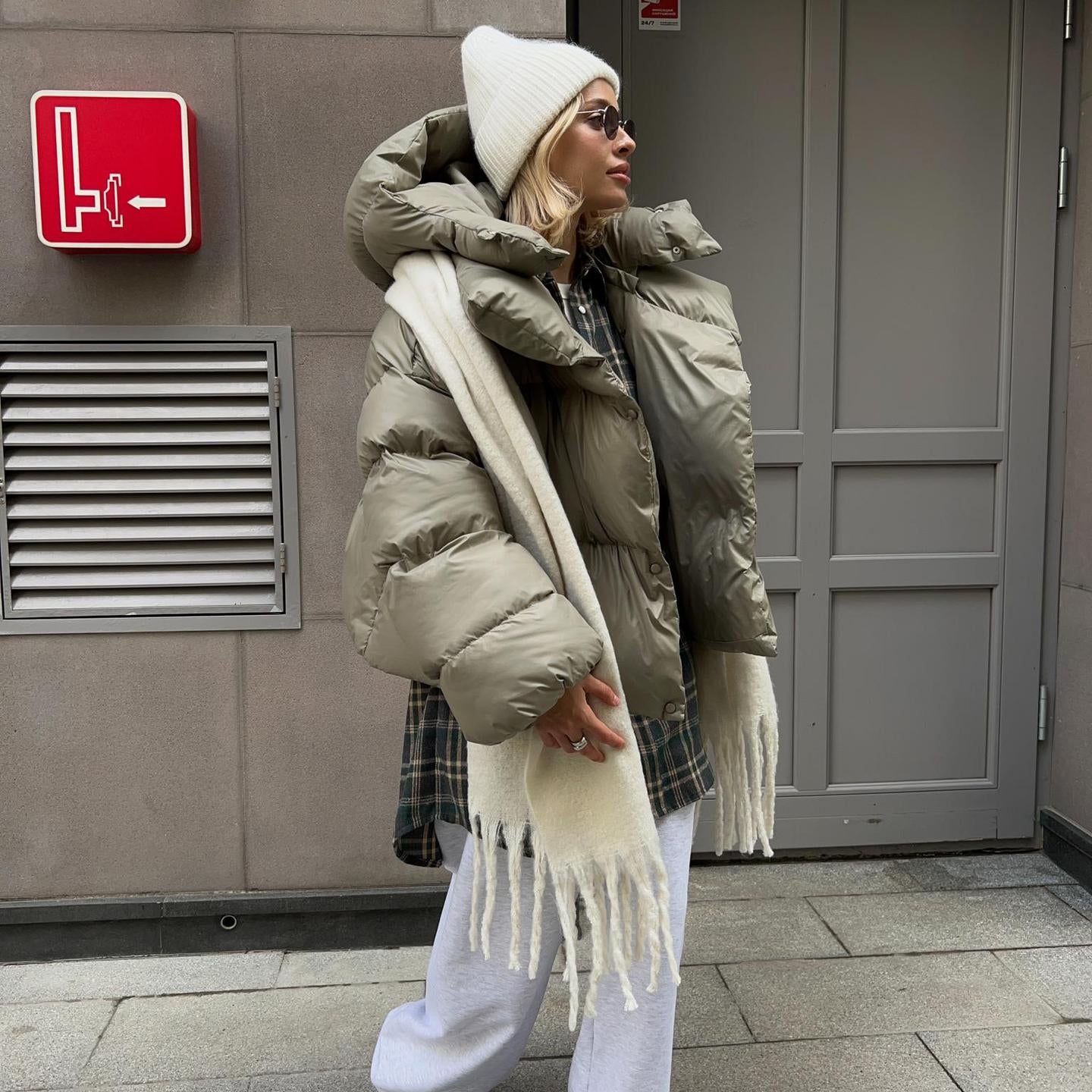 Woman in oversized puffer jacket showcasing fashionable ملابس by Langry