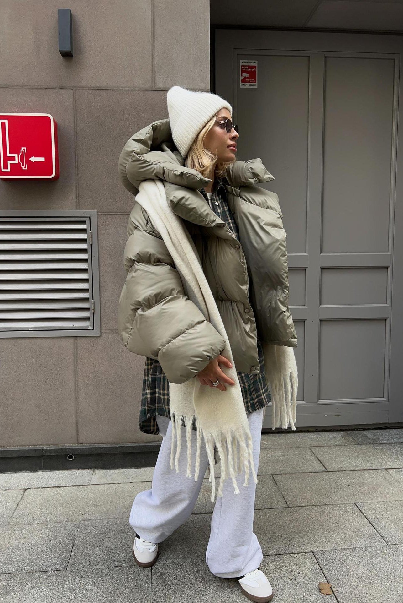 Woman in oversized puffer jacket showcasing fashionable ملابس by Langry