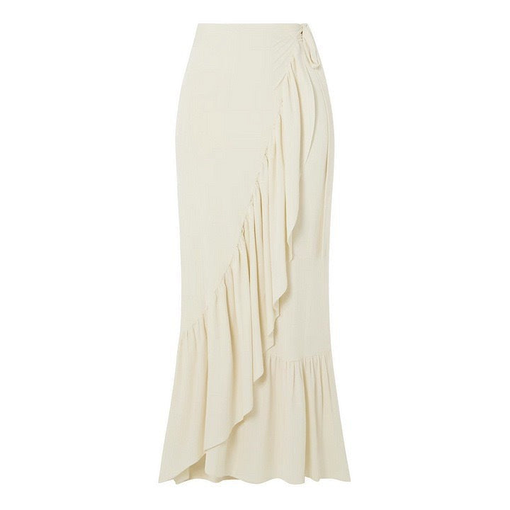 Cream-colored ruffled maxi skirt paired with an elegant retro swimsuit for a chic look