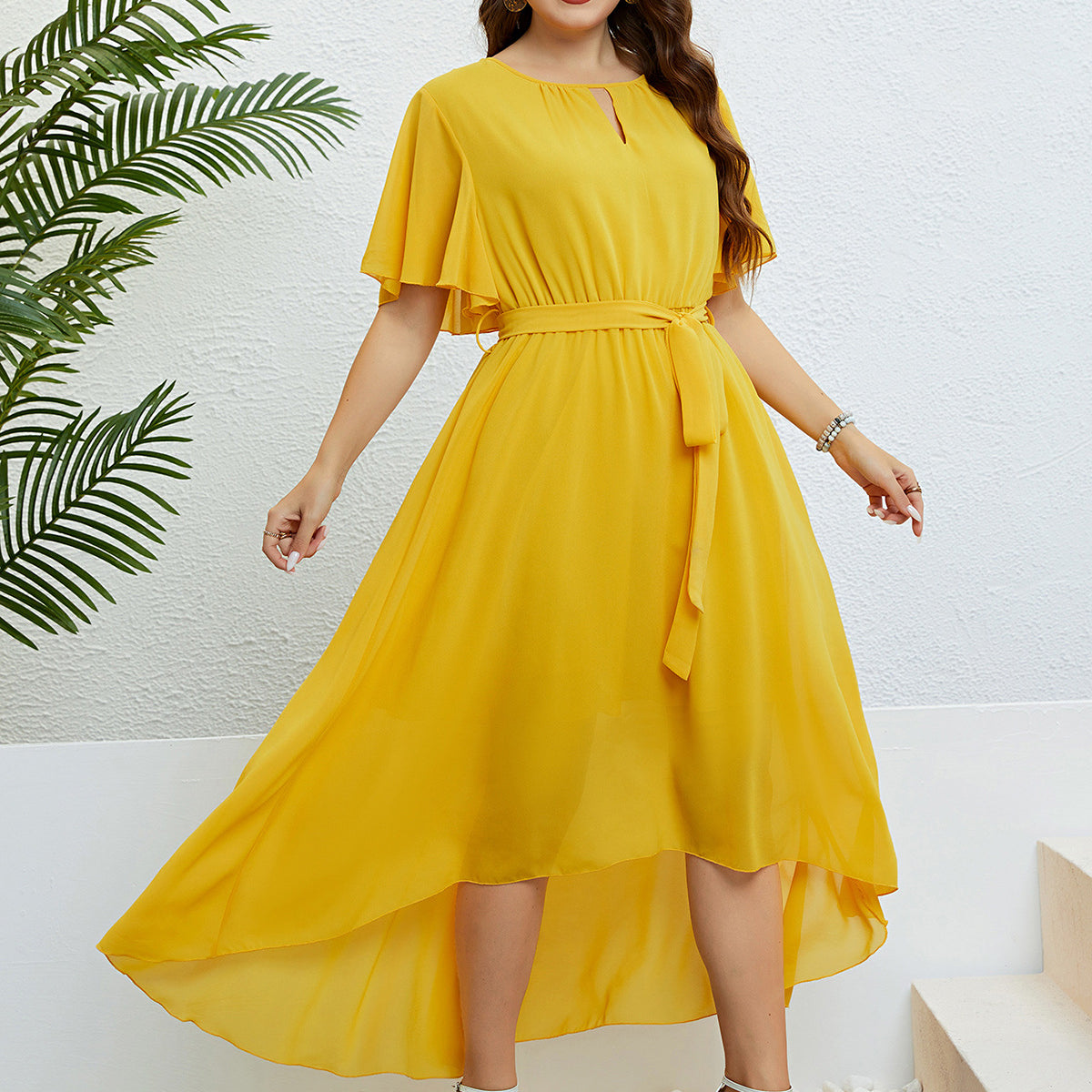 Woman in yellow high-low dress showcasing elegant lace, available with free shipping from Langry