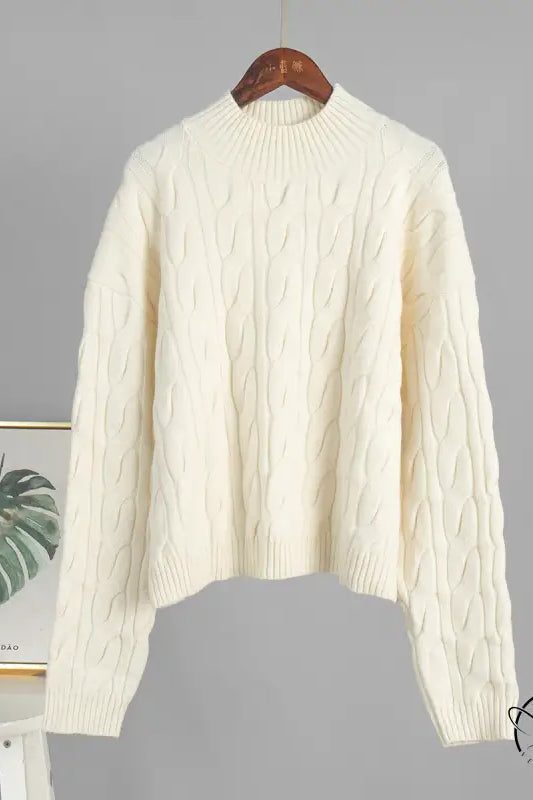 Winter loose knit sweater in cream cable knit on wooden hanger, Langry fashion ملابس