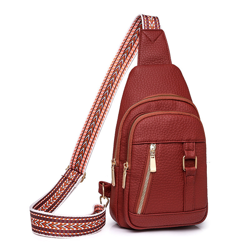 Reddish-brown faux leather sling bag with patterned strap for trendy fashion and ملابس