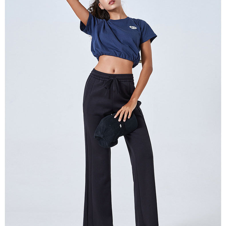 Navy blue crop top with black wide-leg pants and white sneakers for trendy summer fashion
