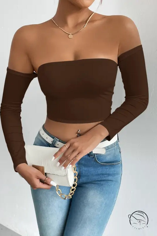 Woman in brown camisole waist trimming short sleeve crop top with jeans