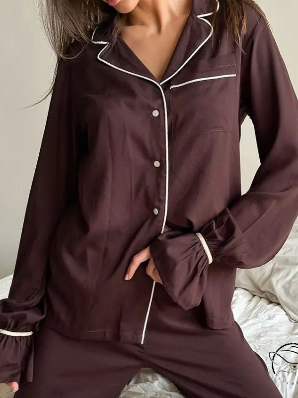 Brown satin langry pajamas with white piping and ruffled cuffs