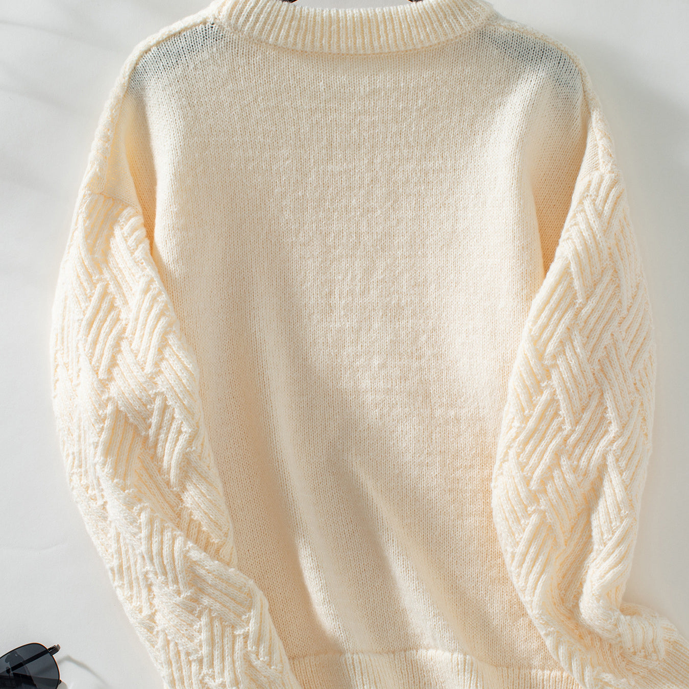 Cream cable knit crew neck sweater with long sleeves for winter fashion