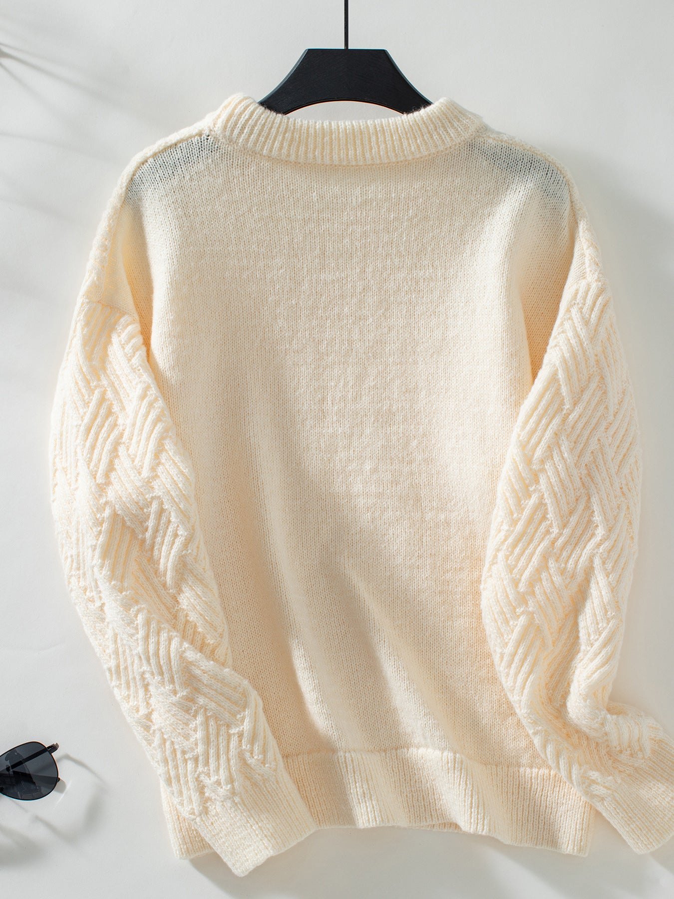 Cream cable knit crew neck sweater with long sleeves for winter fashion