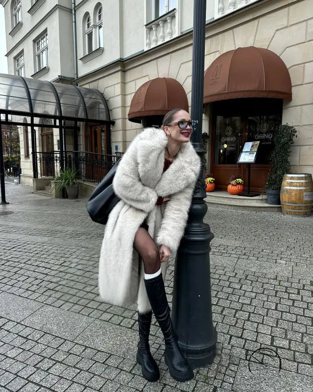 Warm winter faux fur coat in cream with black trim and oversized design