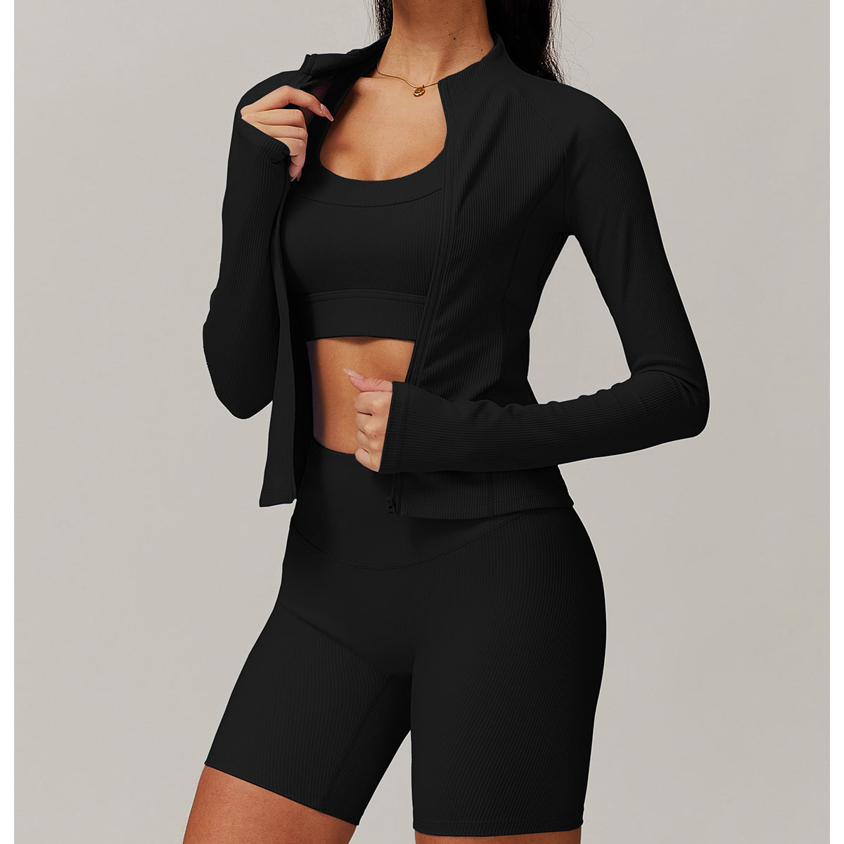 Black athletic two-piece langry workout set featuring a cropped jacket and fitted shorts