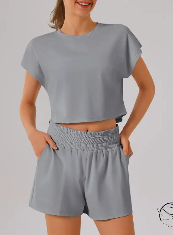 Light gray loose sports yoga fitness set with crop top and shorts
