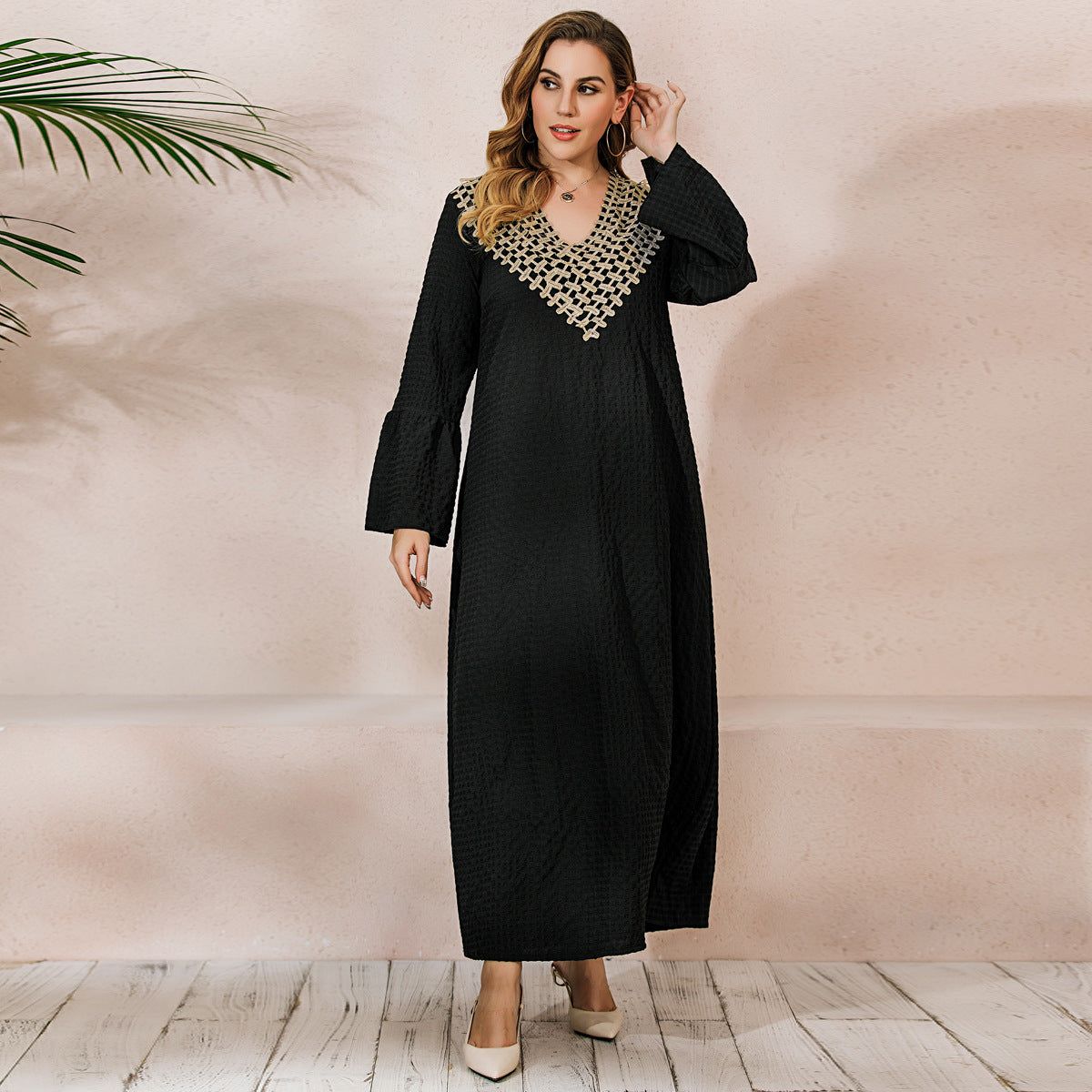 Black long-sleeve robe dress with flared sleeves and gold embroidery for winter style
