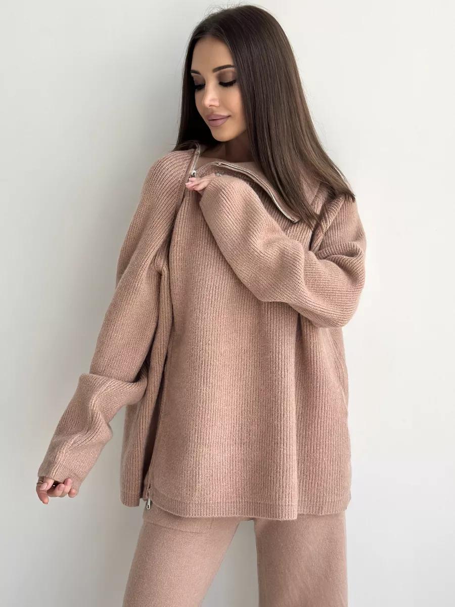 Woman in a beige knit sweater and pants from Langry’s fashion collection ملابس