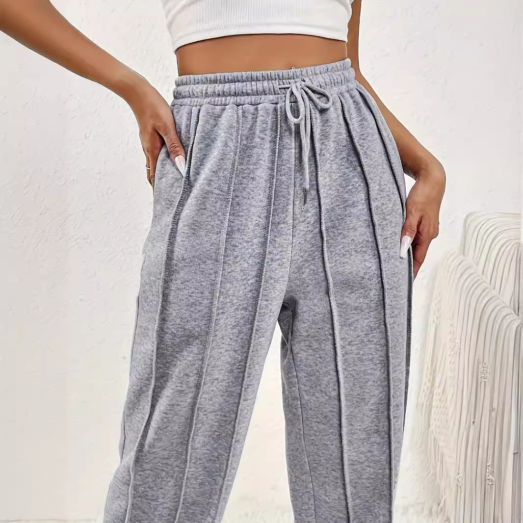 Gray wide leg sweatpants with vertical seams and drawstring waistband for casual fashion