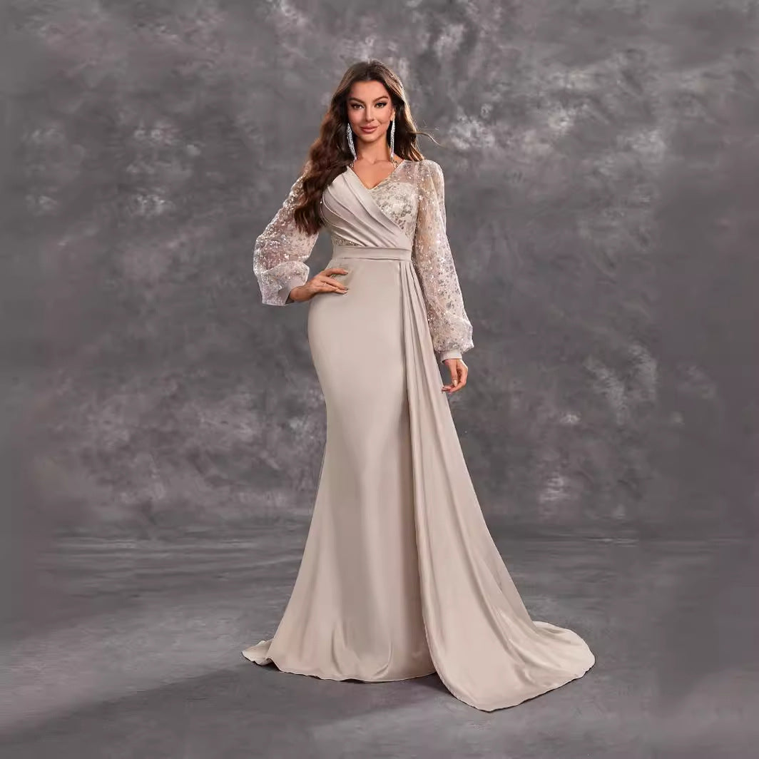Elegant beige evening gown with embellished sleeves, perfect for luxury fashion or ملابس