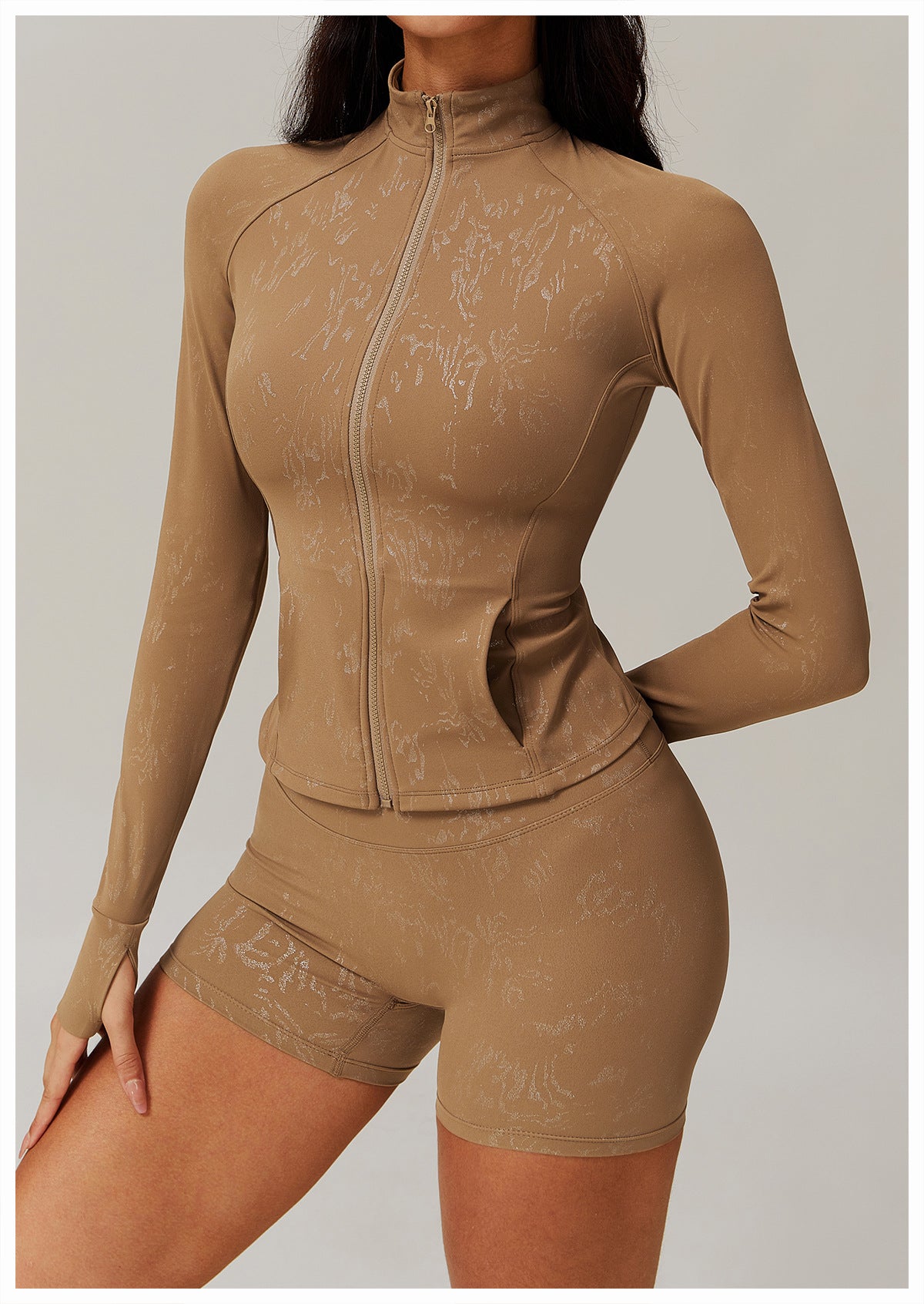 Woman modeling light brown langry fashion full-zip track jacket and biker shorts, ملابس