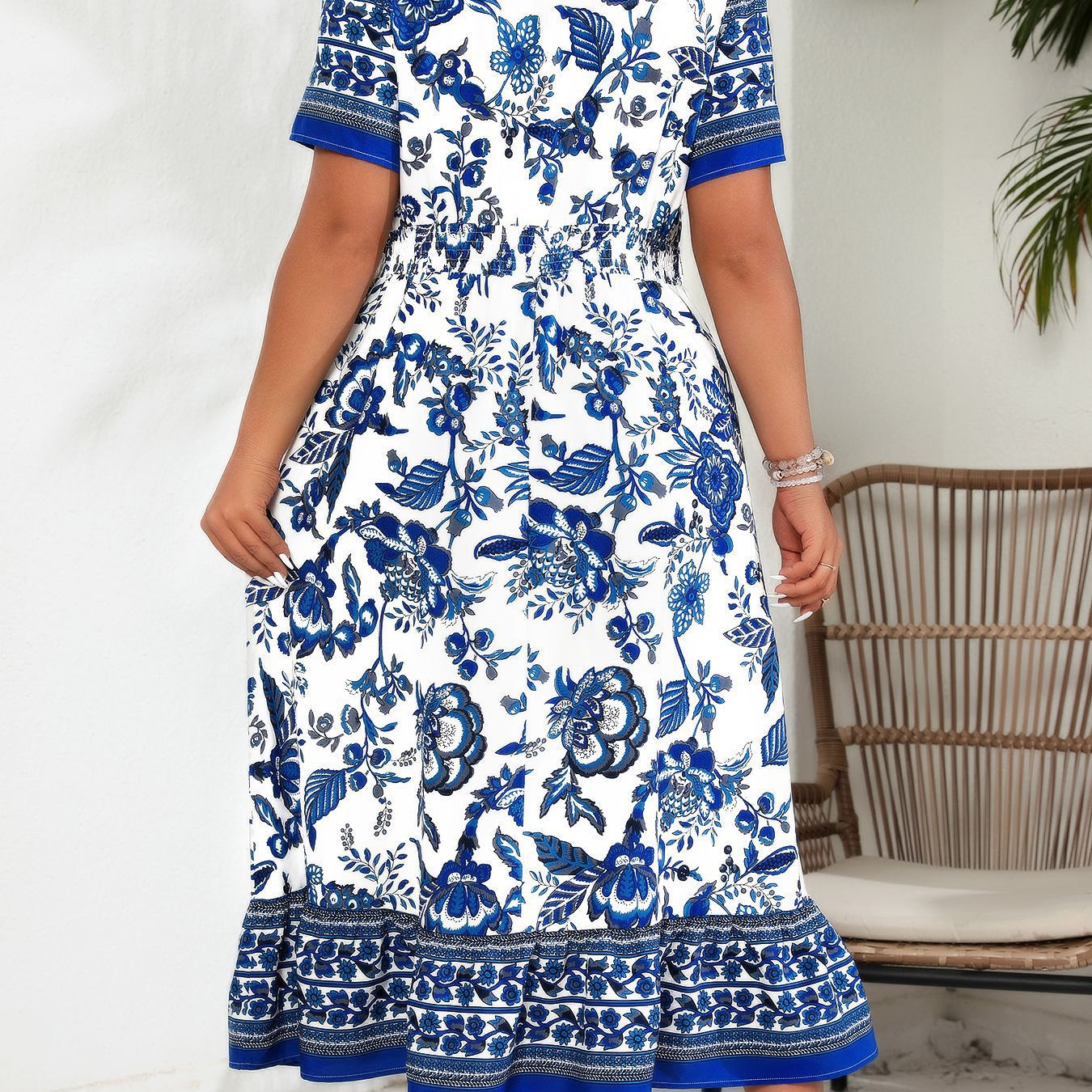 Blue white maxi dress with floral print, short sleeves, and ruffled hem for elegant style