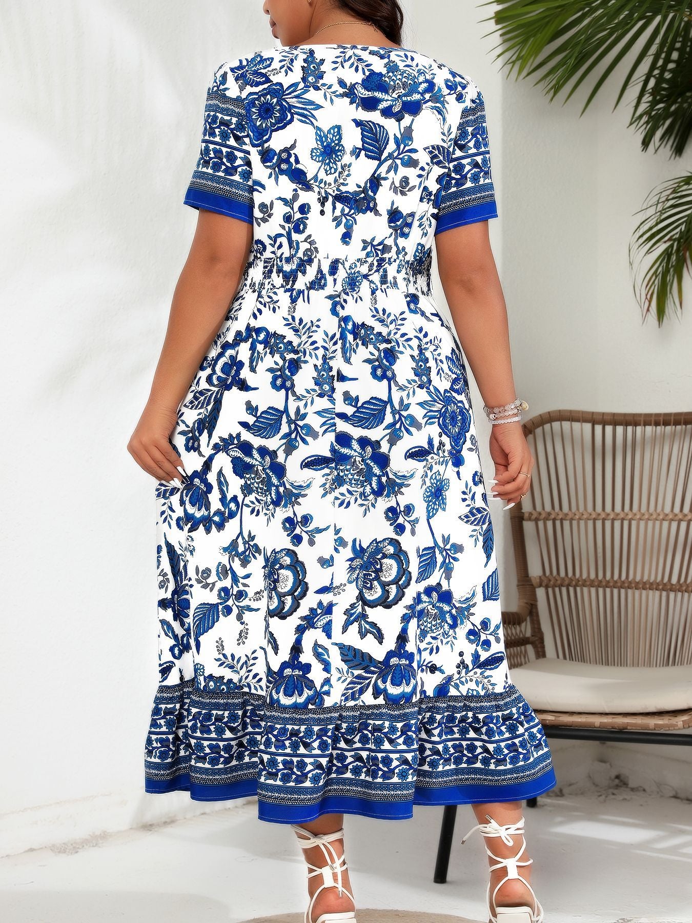 Blue white maxi dress with floral print, short sleeves, and ruffled hem for elegant style