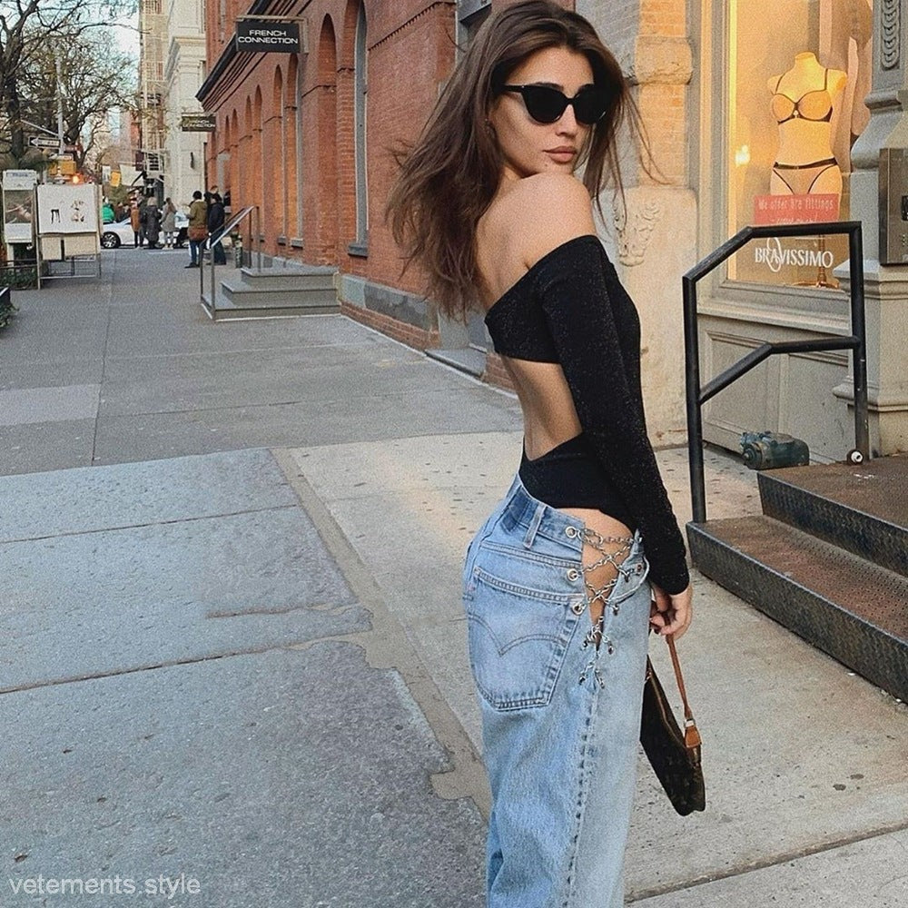 Woman wearing sexy chain straight jeans and off-the-shoulder black top