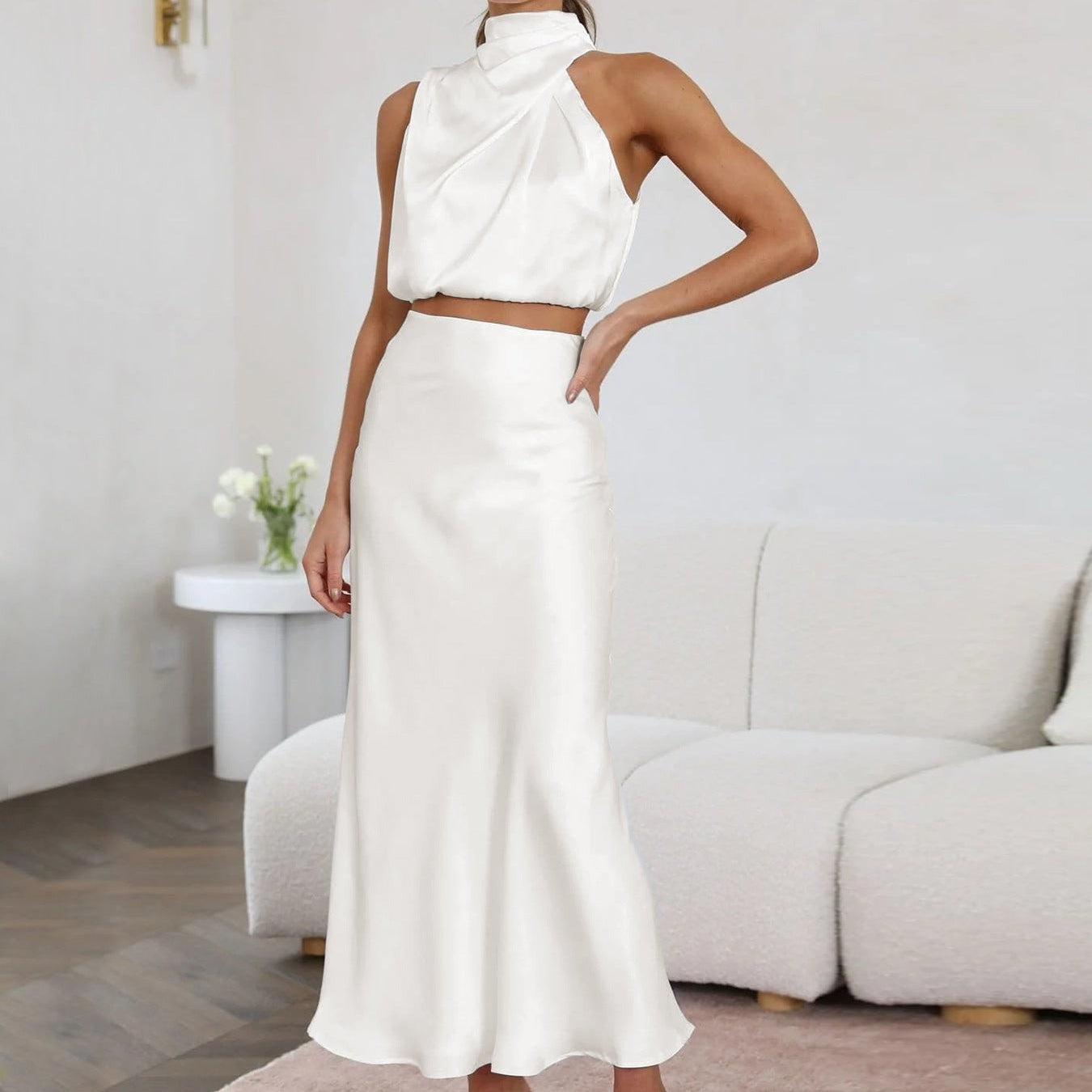 Woman modeling the ENCHANTING DRAPING SKIRT SET in a sexy white satin draping skirt